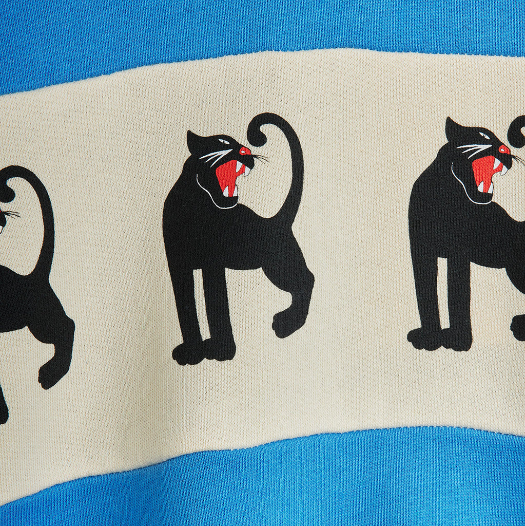Aqua blue cotton sweatshirt with white panel and Mini Rodini iconic panther print. Relaxed fit for kids to 11 years | design closeup