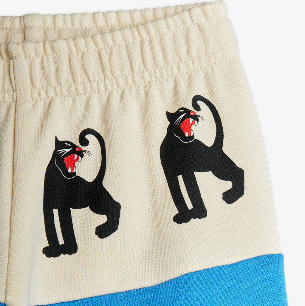 Mini Rodini Panther sweatpants | white hip bad with panther repeated print | beautiufl aqua bottom of pant  elasticized waist and ankles | organic cotton |  close up of panther details