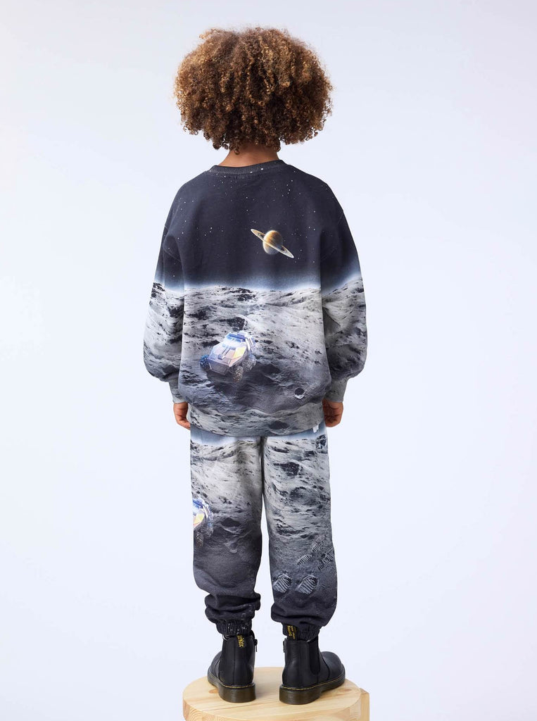 Organic cotton sweatpants with moon landing scene | elastic waist | digital print | elastic at ankles | back of model