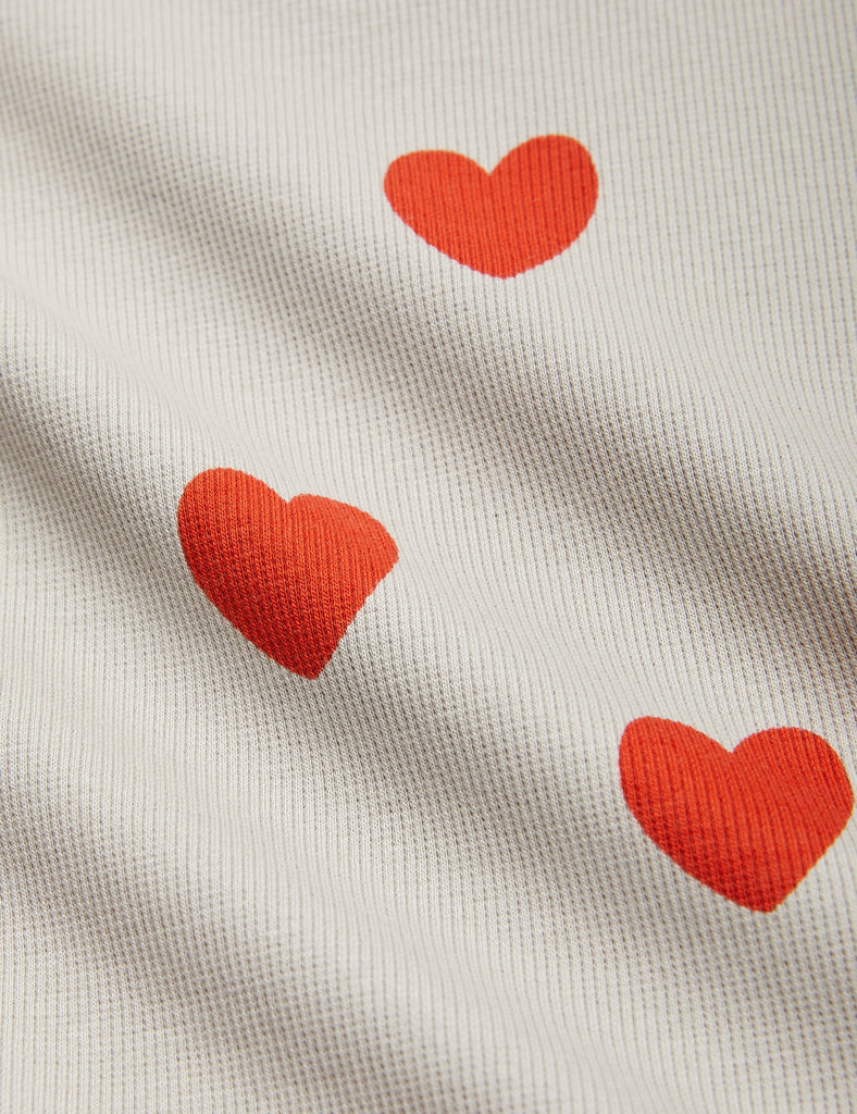 Mini Rodini Grey Turtleneck Shirt covered in Red Hearts | Long Sleeve |Open at wrist and waist | closeupMini Rodini Grey Turtleneck Shirt covered in Red Hearts | Long Sleeve |Open at wrist and waist | closeup
