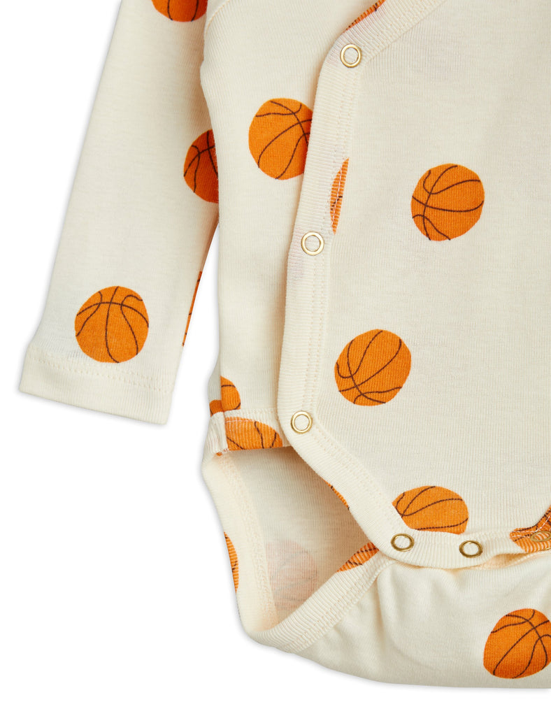 Mini Rodini Newborn Wrap Close Onesie | All-over Basketball Print | Snap Close - closeup