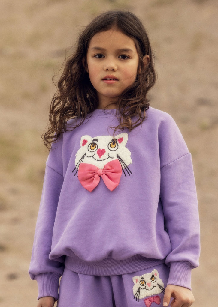 Chenille Cat with a Bowtie on a lavender cotton sweatshirt | crew neck | ribbed at neck, wrist, waist | dropped shoulders | relaxed fit | modeled 