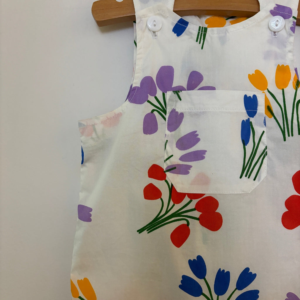 Lightweight Infant Cotton Jumper with Summer Flowers Print | White w/red/yellow/purple/blue floral | Patch Pocket on Front | Button close at shoulders | Snaps at legs for easy changing - top closeup