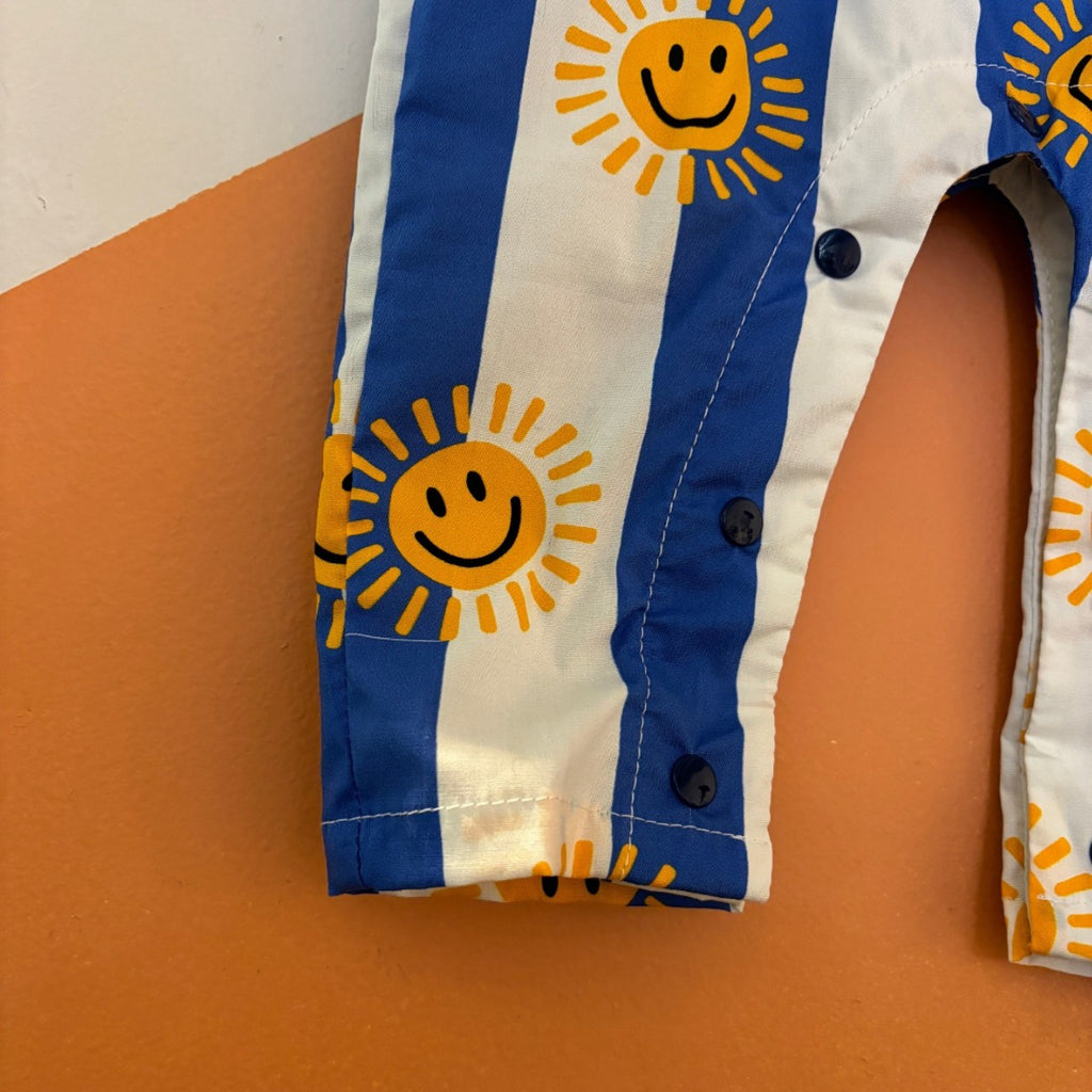 Happy Stripes Cotton Infant romper | Blue & White with Suns | Leg Closeup showing Snap Close