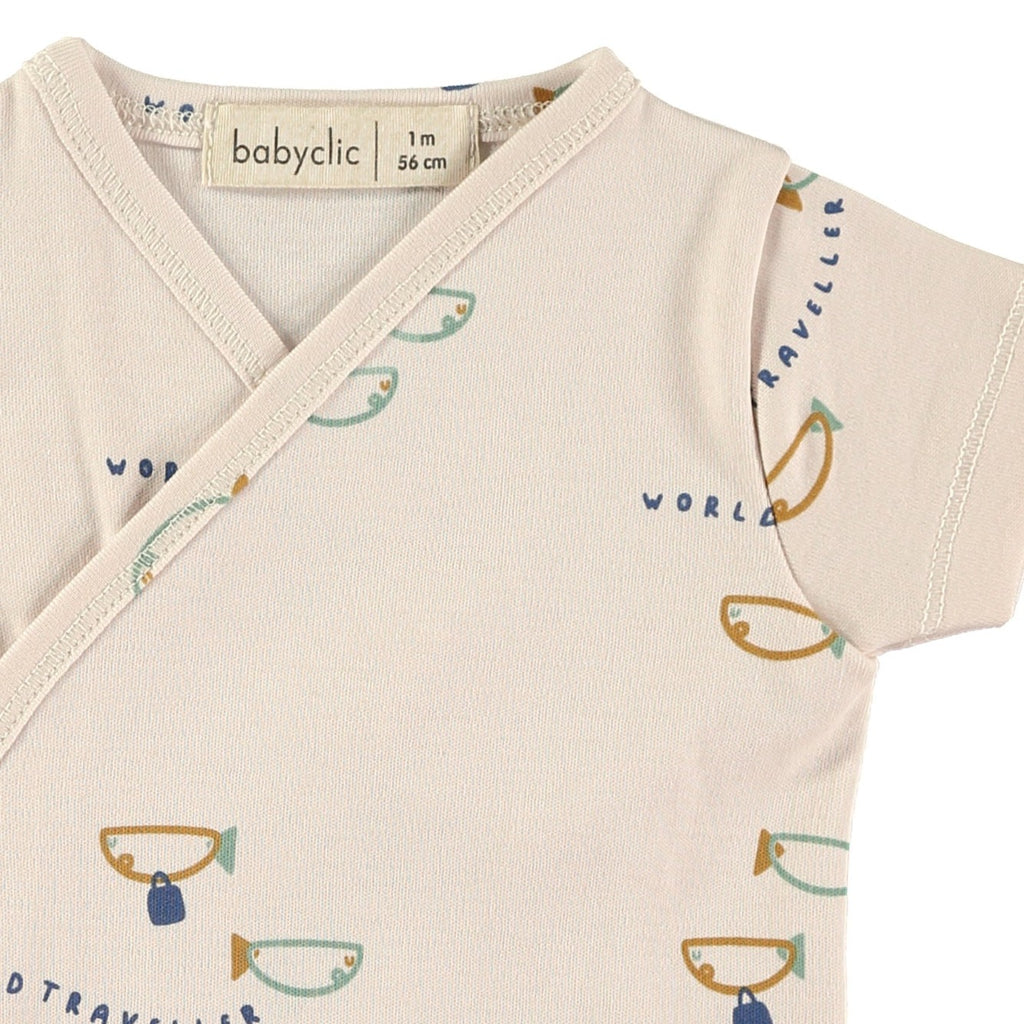 Little Fishes Print on a Soft Organic Cotton Short Sleeve Onesie | Wrap Closure in front | Inside closes with a ribbon tie | Snaps at legs for changing - closeup