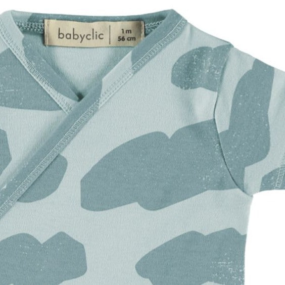Baby Blue Sky & Clouds Print on a Soft Organic Cotton Short Sleeve Onesie | Wrap Closure in front | Inside closes with a ribbon tie | Snaps at legs for changing - closeup