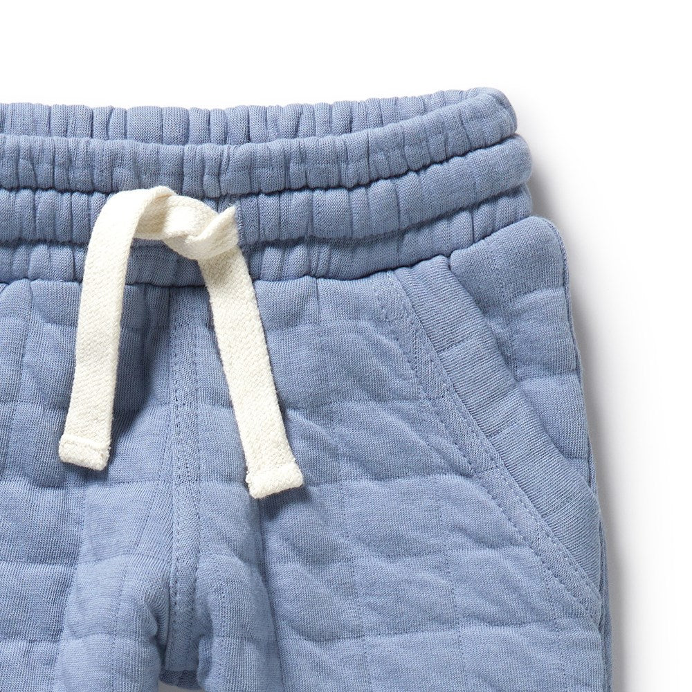 Blue mid weight quilted baby pants with a white drawstring | 100% Organic Cotton | soft elastic waist | side/back pockets | closeup