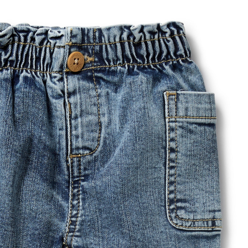 Organic cotton denim infant/toddler pant | side wrap working pockets | soft elastic waist and a front button opening 