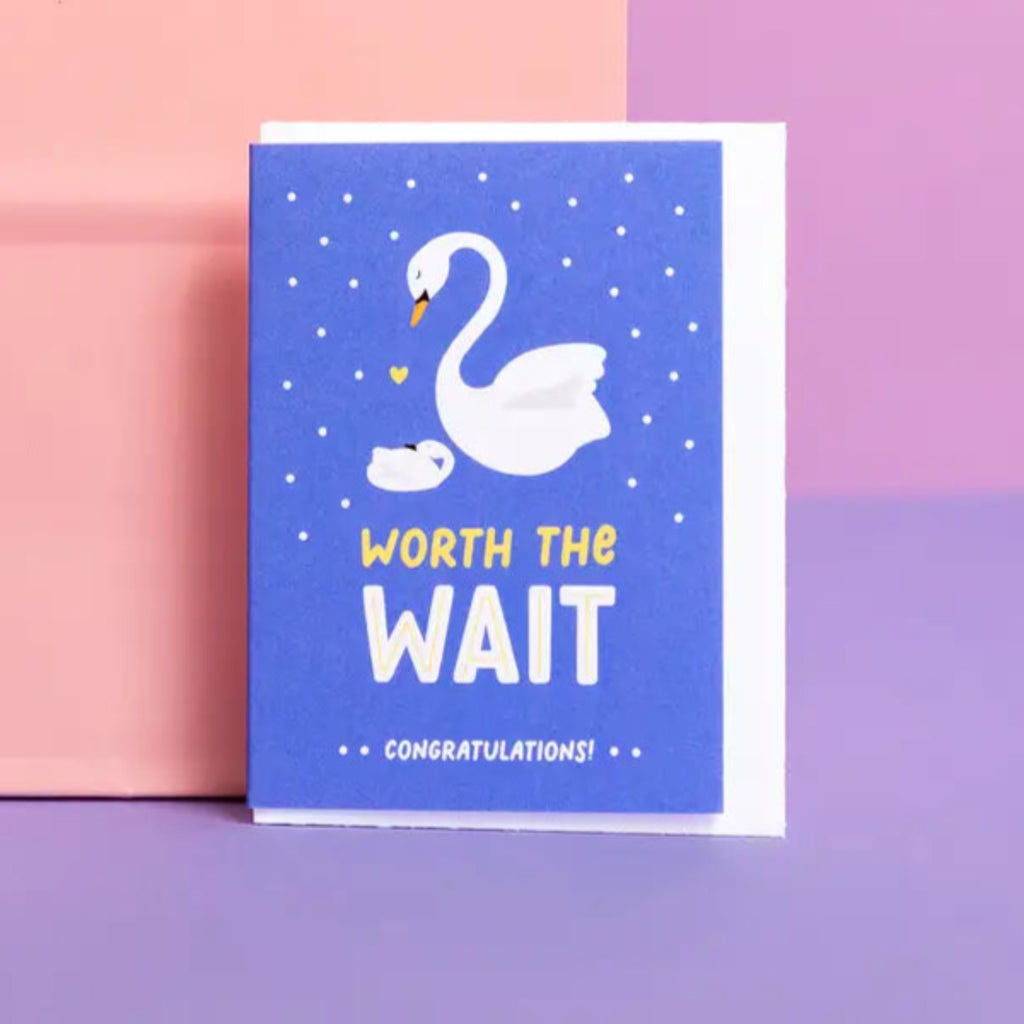 Greeting card with a swan design and 'Worh the Wait' text on a colorful blue background. Under 3.5" wide/high