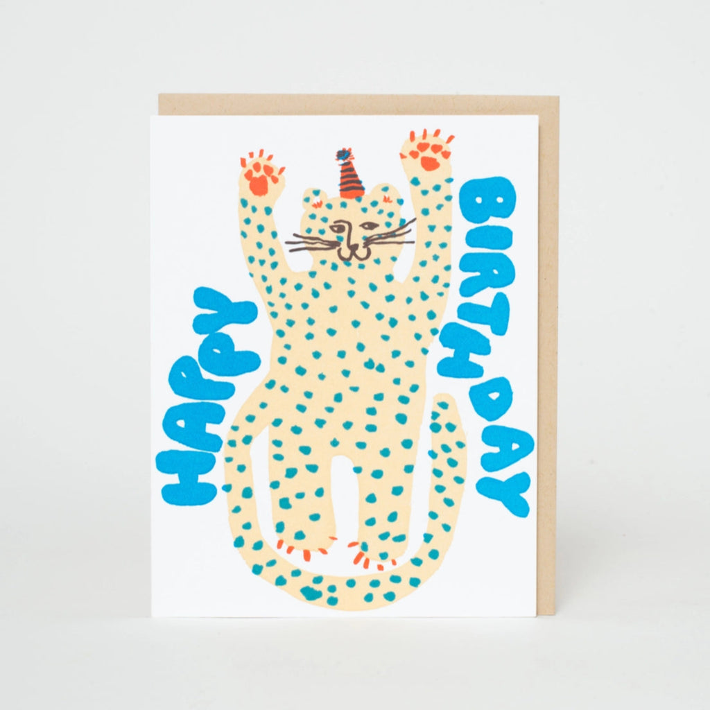 A birthday card with an illustration of a cheetah wih a party hat, with the text 'Happy Birthday' on an white background. A envelope is partially visible behind the card.  Blank inside
