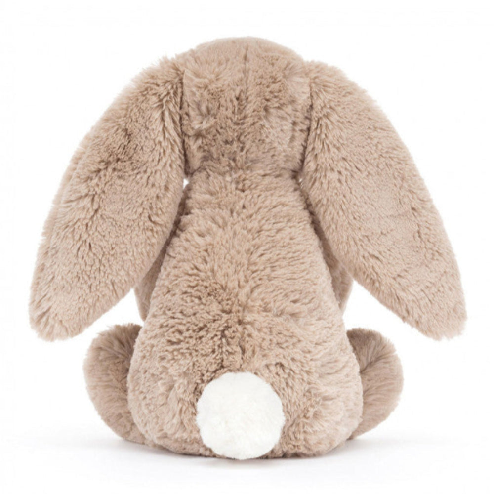 Bashful Bunny holding a tiny, textured amuseables birthday cake, topped with soft cream icing, velveteen strawberries, and a striped candle | 12" long | sits 9" high | Long ears | back view