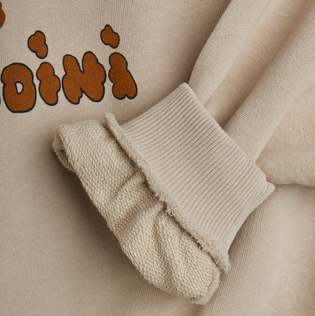 Close-up of light grey Mini Rodini doggie sweatshirt 