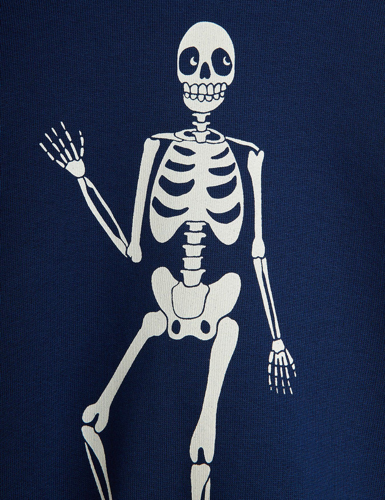 Navy blue cotton sweatshirt ith large bold white skeleton on front | ribbing at neck, wrist, and waist | drop shoulders | closeup