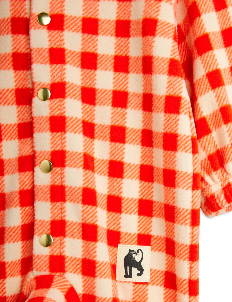 Red and ecru gingham check fleece baby playsuit, snap close in front, elastic wrist and ankles, roomy and soft | closeup