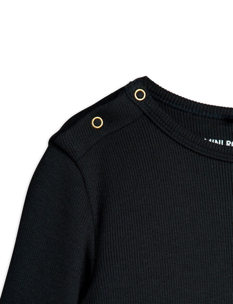 Black Tee by Mini Rodini made with very soft modal fabric, long sleeves ribbed at wrist, snap buttons at shoulder, shoulder closeup