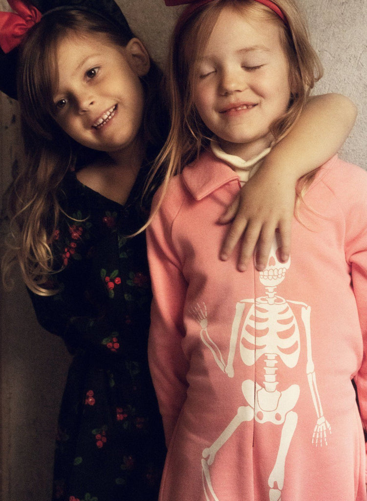 All cotton cotton pink jumpsuit | zip-up front | skeleton graphic on front | elasticized waist in back with 2 pockets