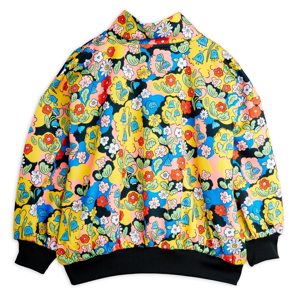 Colorful floral-patterned track pant in soft polyester. Half-zip front, black piping in front, stand-up collar, no-seam sleeve, ribbed at wrist and waist. Top quality Mini Rodini brand | back of top