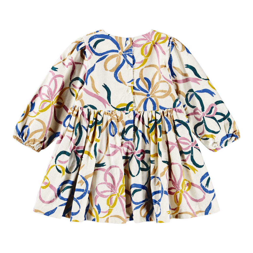 Organic Cotton velvet dress with ribbon print | off-white with blue, pink, gold ribbons | elastic at wrists | button clost in back | full skirt | empire waistline | back of dress