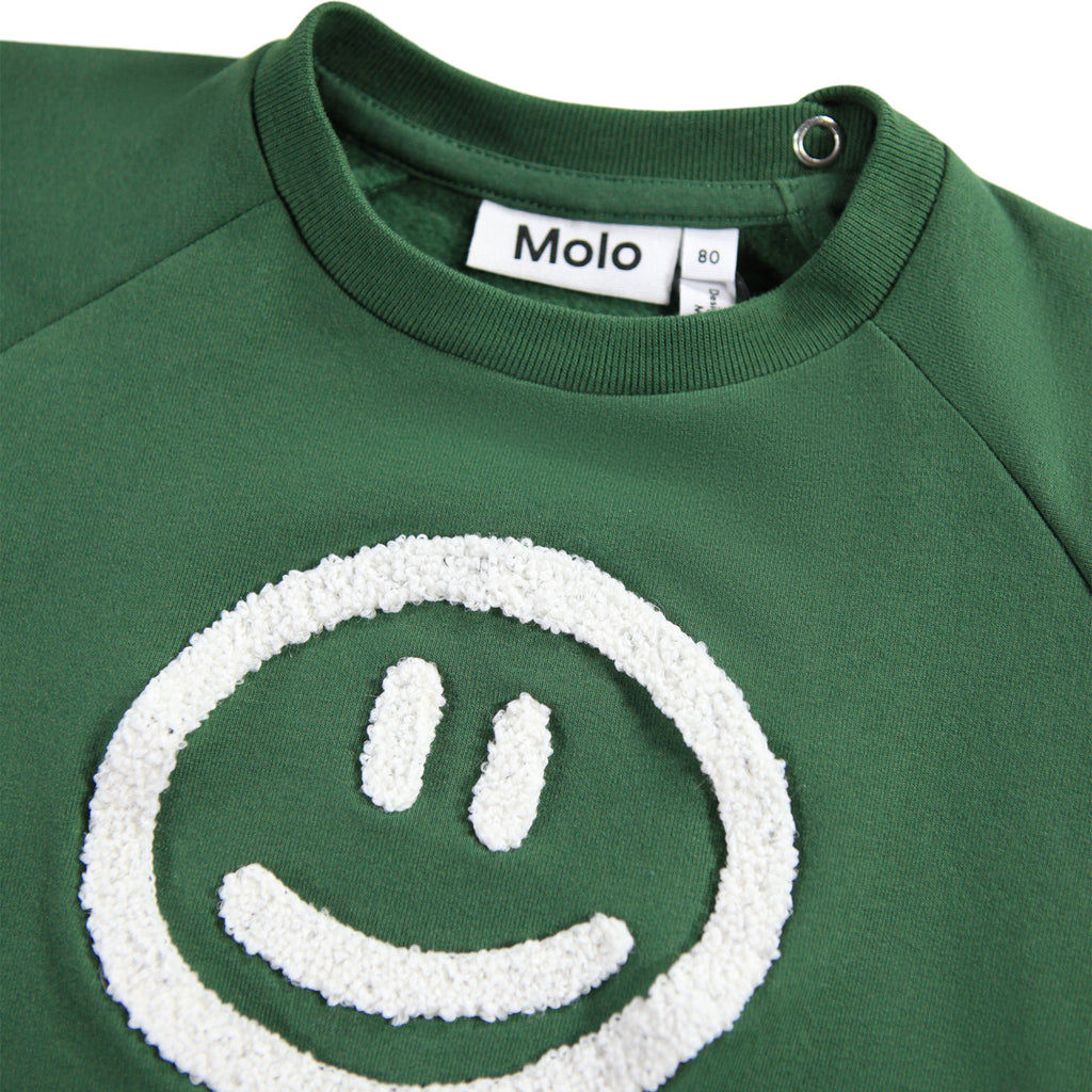 Kids pine green sweatshirt with White Smiley Face | snaps at neck | 3 month to Toddler 4 | banded at wrist & waist | relaxed fit | raglan sleeves | close up of textured smiley face