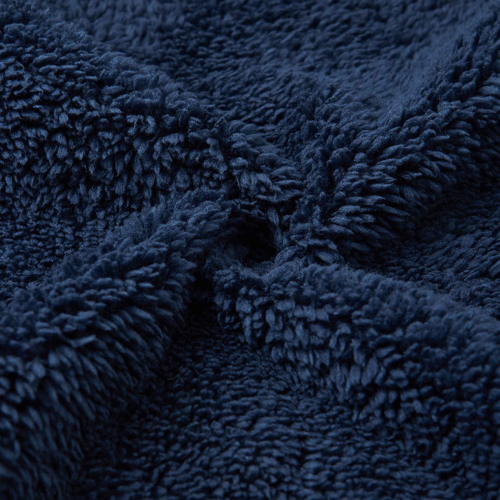 Toddler fleece zip up jacket | standup collar | yellow, green & blue accents | Finnish character patch | binding at wrist and waist | fleece pile outside, smooth fleece inside | closeup