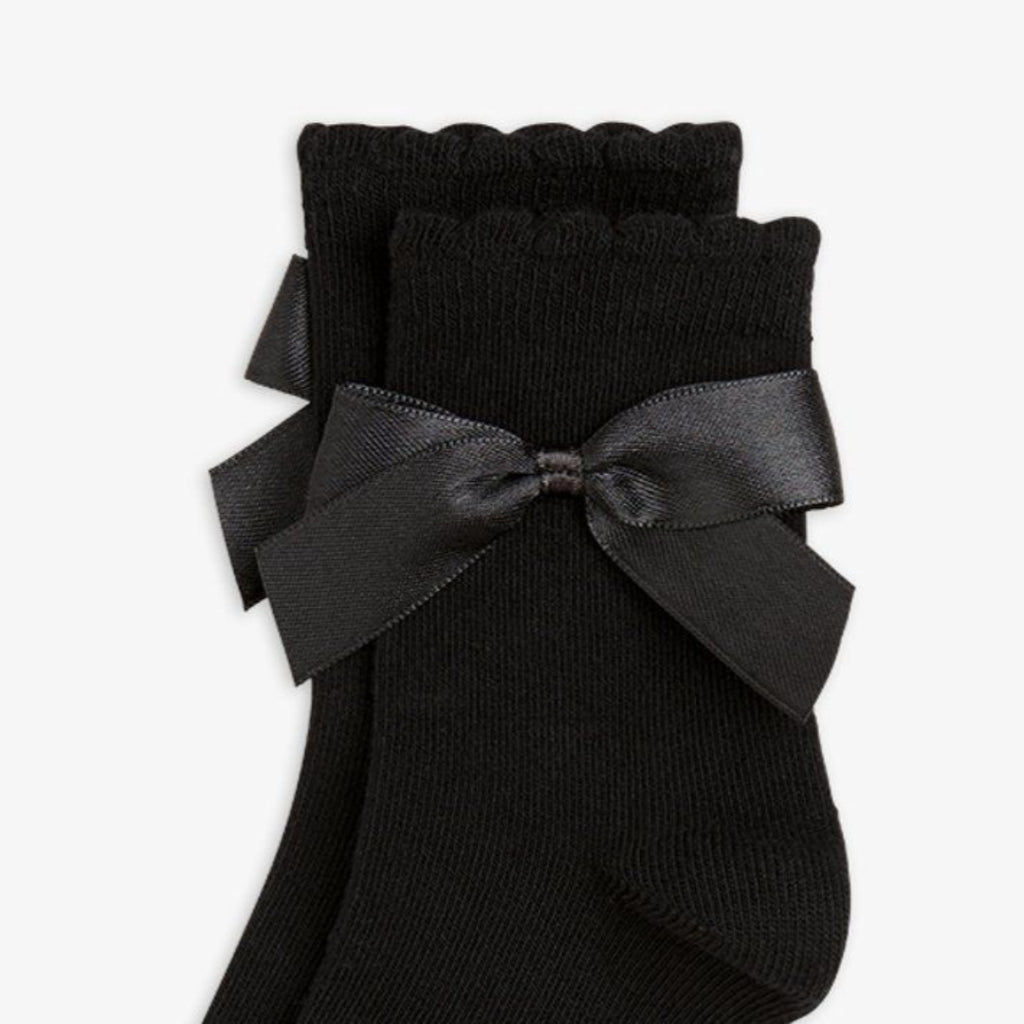Black socks with a satin bow and 'Mini Rodini' branding 