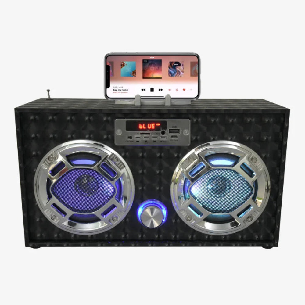 Boombox Speaker that connects to devices or tunes to radio | recharging cord included | fun for kids 8 and up | shown with handle holding phone for wireless connect | digital display 